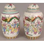 A PAIR OF CHINESE FAMILLE ROSE PORCELAIN JARS & COVERS, circa 1900, each painted with numerous