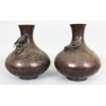 A LARGE PAIR OF SIGNED JAPANESE MEIJI PERIOD BRONZE VASES, one cast in high relief with a bird