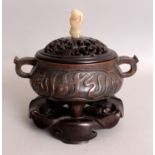 AN ISLAMIC MARKET CHINESE BRONZE TRIPOD CENSER WITH FITTED WOOD COVER & STAND, the bronze itself