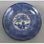 AN EARLY 20TH CENTURY JAPANESE PORCELAIN DISH, decorated with a ho-ho phoenix above paulownia,