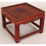 A 19TH/20TH CENTURY CHINESE SQUARE SECTION CARVED WOOD STAND, with stretchers and a key-fret frieze,