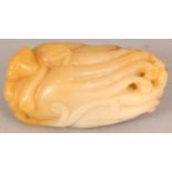 AN UNUSUAL CHINESE JADE CARVING, modelled in the form of a monkey clasping a finger citron, the