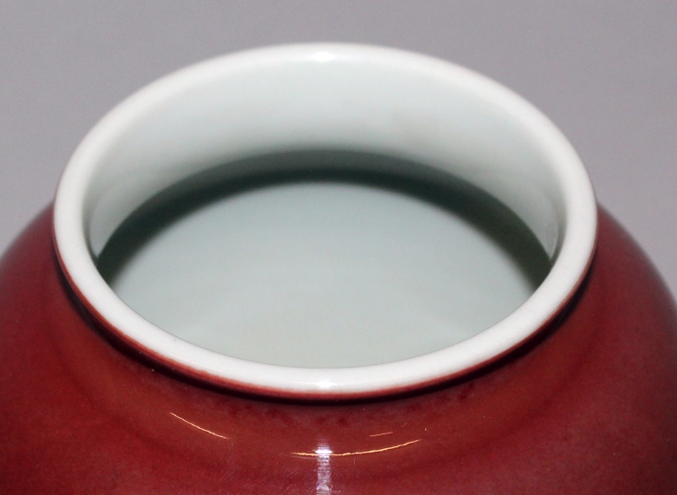 A CHINESE SANG-DE-BOEUF PORCELAIN VASE, the glaze slightly mottled, the base unglazed, 7.5in high. - Image 3 of 4