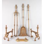 A SET OF THREE BRASS FIRE IRONS and PAIR OF STANDS.