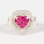 AN 18CT GOLD, RUBY AND DIAMOND HEART SHAPED RING.
