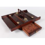 A GOOD 19TH CENTURY ROSEWOOD FOLDING TRAVELLING INKWELL, with two flaps, two glass bottles, small