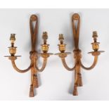 A PAIR OF FRENCH ORMOLU TWO-LIGHT WALL SCONCES with tassels (for restoration).