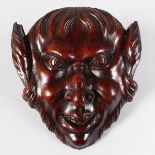 A 19TH CENTURY CARVED WALNUT HEAD OF PAN. 7ins x 6.5ins.