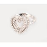 AN 18CT WHITE GOLD DIAMOND SET HEART SHAPED RING.