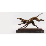 A BRONZE OF TWO RACING GREYHOUNDS. Signed, on a marble base.