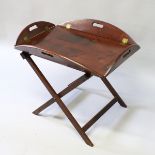 A BUTLER'S 19th CENTURY MAHOGANY TRAY ON STAND with folding sides and hand apertures, on a cross