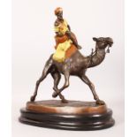 A LARGE AUSTRIAN COLD CAST GROUP, MAN RIDING A CAMEL, on an oval marble base. 15ins high.