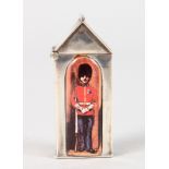 A SILVER NOVELTY MINIATURE SEWING BOX with an enamel soldier on the door.