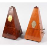 TWO FRENCH WOODEN CASED METRONOMES. 9ins high.