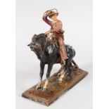 AN AUSTRIAN PAINTED METAL AMUSING NOVELTY LIGHTER, a cowboy on a horse. 9ins high.