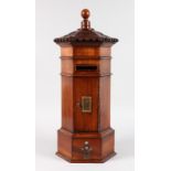 A GEORGIAN STYLE MAHOGANY OCTAGONAL "ROYAL MAIL" LETTERBOX, the top carved with acanthus and bead