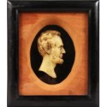 A framed and glazed wax portrait of Abraham Lincoln.