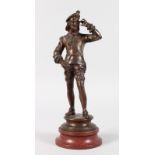A GOOD 19TH CENTURY FRENCH BRONZE OF A WANDERING MINSTREL, a mandolin on his back and standing on