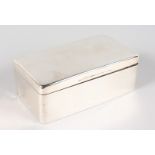 A PLAIN SILVER CIGARETTE BOX AND COVER with cedar wood liner. 7ins long. Birmingham 1913.