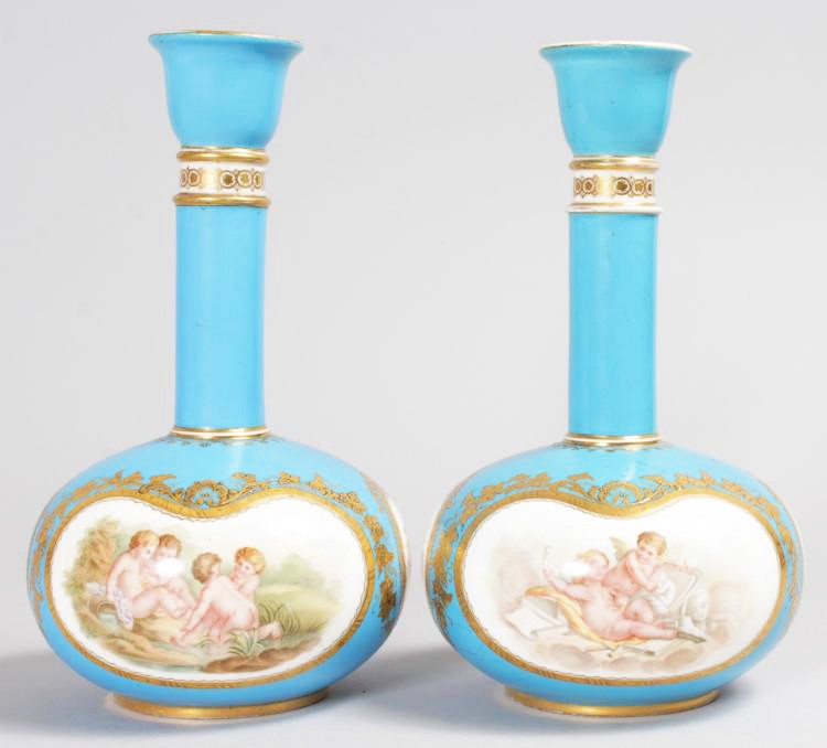 A SUPERB PAIR OF COALPORT BOTTLE VASES, with blue ground edged in gilt, painted with reverse