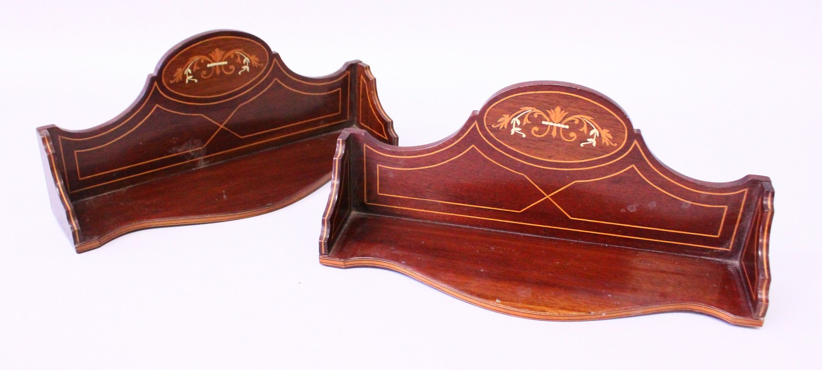 A SMALL PAIR OF VICTORIAN MAHOGANY SERPENTINE FRONTED OPEN SHELVES. 1ft wide.