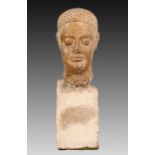 AN UNUSUAL STONE HEAD OF A MAN, POSSIBLY GRAECO-ROMAN, the hair dressed, mounted on a stone