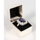 A SILVER COCKTAIL RING in a silver box.