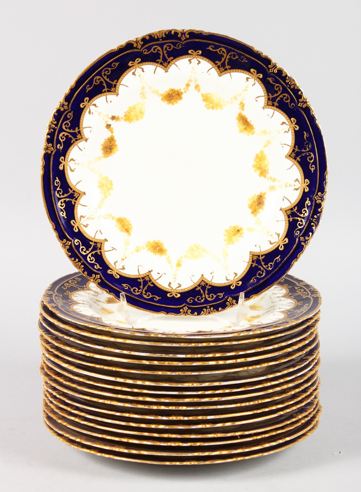 A SET OF SIXTEEN ROYAL CROWN DERBY PLATES, 8.5ins diameter, with blue and gilt borders.