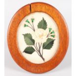 AN OAK FRAMED INLAID OVAL MARBLE PICTURE.