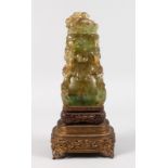 A GOOD CARVED GREEN QUARTZ VASE AND COVER on a pierced wooden stand. 12ins high, including stand.