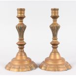 A PAIR OF "LOUIS XV" ORMOLU CANDLESTICKS on shaped bases. 10ins high.