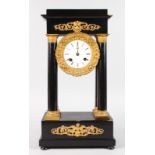 AN EMPIRE EBONY FOUR PILLAR CLOCK with eight-day drum movement, striking on a single bell. 17.5ins