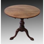 A GEORGIAN MAHOGANY CIRCULAR TILT TOP TRIPOD TABLE, on centre column support and curving legs with