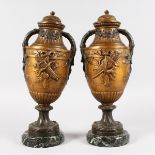 A PAIR OF FRENCH BRONZE TWO-HANDLED URNS, on circular marble bases. 14ins high.