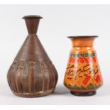 AN ISLAMIC COPPER BOUND LEATHER BULBOUS VASE, with engraved copper and flower heads, 8ins high,