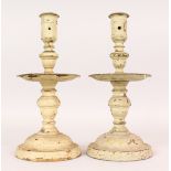 A PAIR OF EARLY DUTCH BRASS CANDLESTICKS with drip pans. 10.5ins high. (Painted).