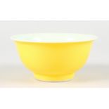 A YELLOW CHINESE BOWL. Six character mark. 5ins diameter.