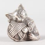 A SILVER PIN CUSHION, cat holding a ball of wool.