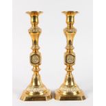 A PAIR OF BRASS CANDLESTICKS. 10ins high.