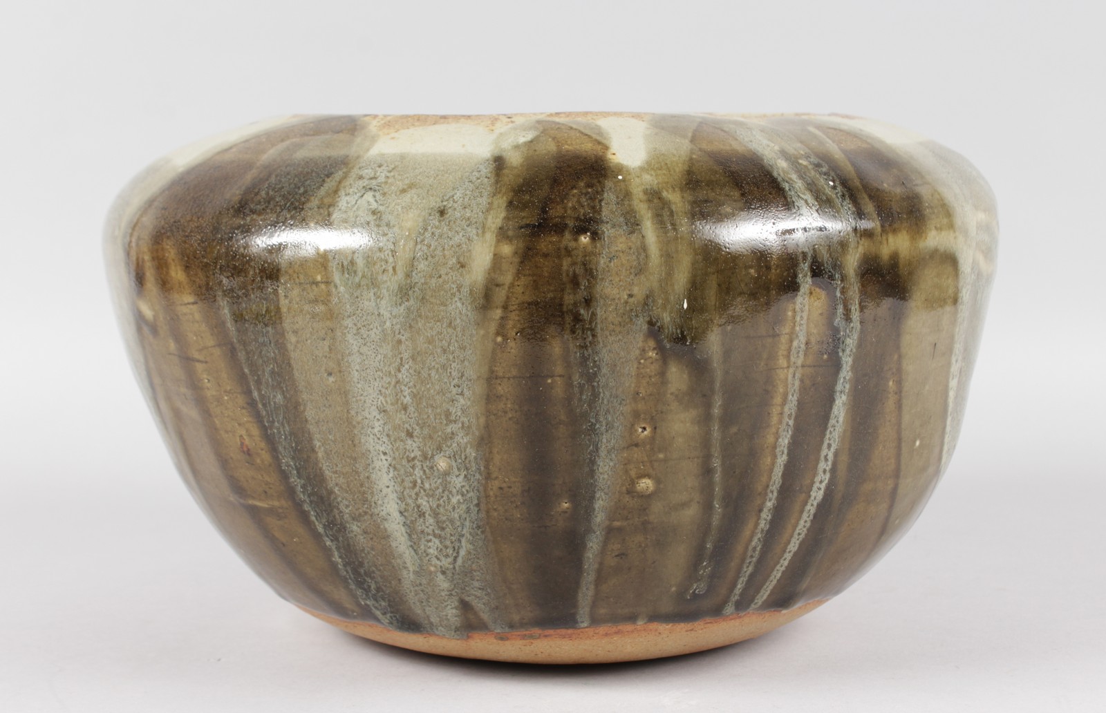 A LARGE STONEWARE POTTERY BOWL. Incised signature JANET HARPER. 7ins high, 12ins diameter.