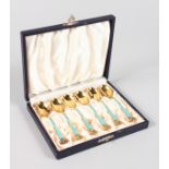 A SET OF SIX DANISH STERLING SILVER GILT AND ENAMEL COFFEE SPOONS.