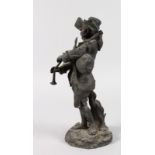 E. CLAVIER A BRONZE OF A MAN playing bagpipes. Signed. 11.5ins high. Very Dirty.