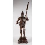 19TH CENTURY FRENCH A LARGE BRONZE OF A 16TH-17TH CENTURY SOLDIER carrying a sword and staff.
