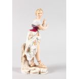 A CONTINENTAL FIGURE OF A CLASSICAL YOUNG LADY in a floral dress. 21cms high.