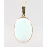 A 9CT GOLD OVAL OPAL PENDANT AND CHAIN.