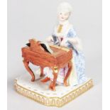 A MEISSEN SENSES GROUP, "SOUND", a seated lady playing a piano. Cross swords mark in blue.