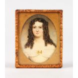 A MINIATURE OF A YOUNG LADY in a leather case.