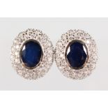 A PAIR OF SILVER SAPPHIRE SET CLUSTER EARRINGS.