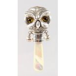 A BABIES SILVER OWL RATTLE with mother-of-pearl handle.