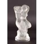 A LALIQUE GROUP OF TWO NUDES sitting on a tree stump. Etched Lalique, France with LALIQUE LABEL. 5.